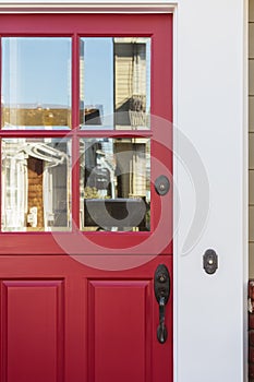 Crop of red front door with reflection