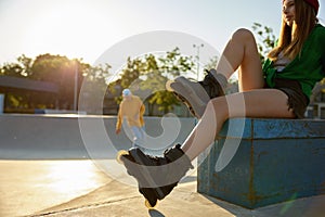 Crop shot of relaxed woman sitting on rollerdrom
