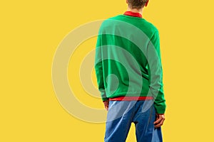 Crop shot of young man in bright colored clothes isolated on yellow background