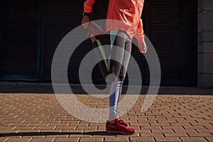 Crop of sporty woman stretch legs do warmup before training