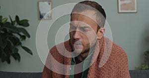 Crop view of bearded guy sneezing and using handkierchief while having cold . Man in 40s getting sick and feeling bad