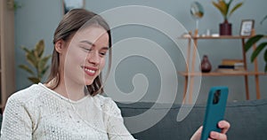 Crop view of deaf woman having video conversation and showing with sign language phrase Fine news. Female person smiling