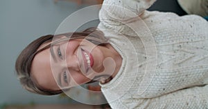 Crop view of female person having video call and using smartphone frontal camera. Pretty woman saying with sign language