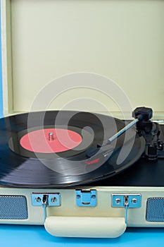 crop Vintage vinyl player black plate and plays. Vertical photo