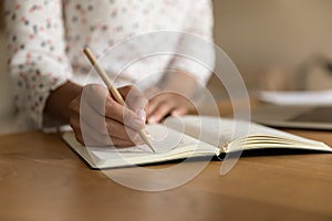 Crop of woman handwrite make notes in notebook