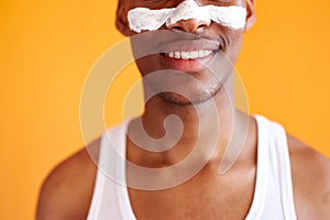 Cropped african man with problematic skin and hyperpigmentation applied mask on his face