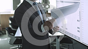 Cropped bearded businessman reading documents with data