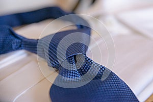 Cropped blue necktie on a white blurred background