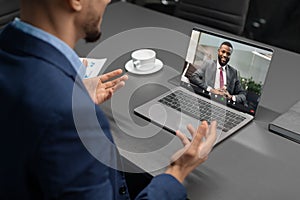 Cropped of businessman having video conference with black man