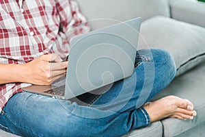 Cropped close-up image of a businessman`s hands typing working on a laptop at the home office. Freelancer, remote occupation,