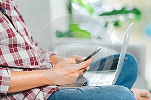 Cropped close-up image of a businessman`s hands typing working on a laptop at the home office. Freelancer, remote occupation,