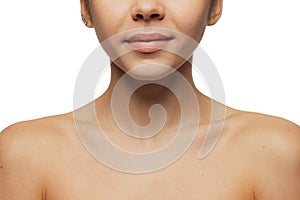 Cropped close-up image of female lips, cheecks and nose isolated over white studio bacground