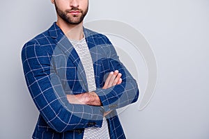 Cropped close up photo of masculine virile man with arms crossed in checkered blazer isolated grey color background