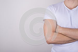 Cropped close up photo portrait of professional entrepreneur student wearing white simple t-shirt standing with crossed arms