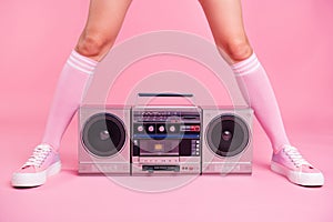 Cropped close up photo skinny perfect ideal she her lady legs opposite standing boom box play between teens hanging out