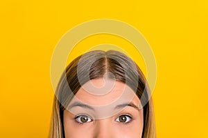 Cropped close up portrait of teen girl half face eyes look camera isolated on bright yellow color background