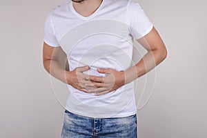 Cropped close up studio photo portrait of upset sad scared worried troubled gut having stomach ache disorder wear denim pants isol