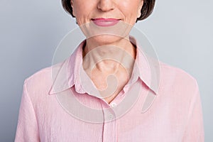 Cropped close-up view portrait of attractive cheery middle-aged woman career isolated over gray pastel color background