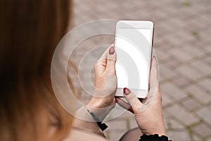 Cropped close up of woman hands holding and using mobile phone, smartphone with empty white screen