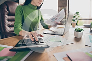 Cropped closeup photo of busy business lady notebook table hold paper stats calculating numbers sums money income sit