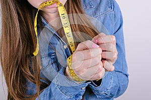 Cropped closeup photo portrait of sad frustrated helpless dependent addicted she her lady holding tied hands with yellow tape