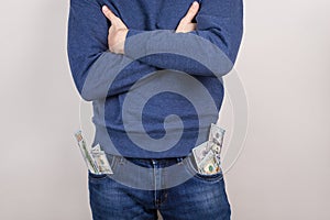 Cropped closeup photo portrait of satisfied cool handsome guy holding usa cash in pockets isolated grey background