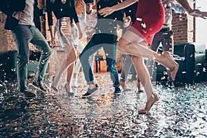 Cropped closeup photo of slim perfect legs girls guys meeting rejoicing dance floor x-mas party glitter flying wear