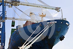 Cropped Cranes By Cargo Containers In Ship