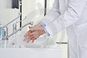 Cropped Doctor washing Hands Before Operation