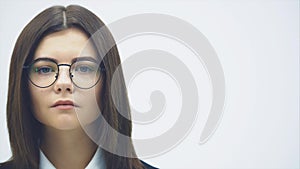 Cropped face of attractive businesswoman looking up at the camera with serious confident face expression.