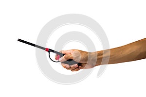 A cropped of female hand holding gas lighter gun against white b