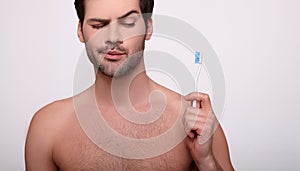 A cropped frame, a Caucasian guy with a toothbrush