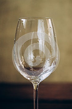 Cropped glass of white wine on a rustic wooden brown background. rest, holiday, party. alcoholic drink closeup. copy space