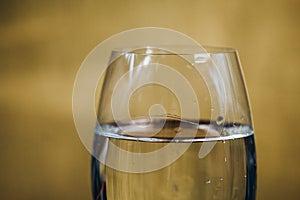 Cropped glass of white wine on a rustic wooden brown background. rest, holiday, party. alcoholic drink closeup. copy space