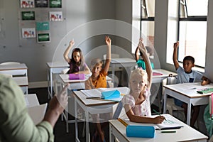 Cropped hand of african american young male teacher teaching multiracial students with hand raised