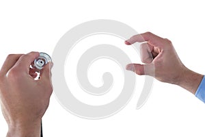 Cropped hand on doctor holding stethoscope while using invisible interface