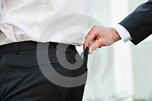 Hand Pickpocketing Wallet Of Businessman