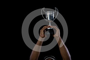 Cropped hand on sportsperson holding trophy photo