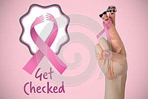 Composite image of cropped hand of woman with pnik breast cancer awareness ribbon photo