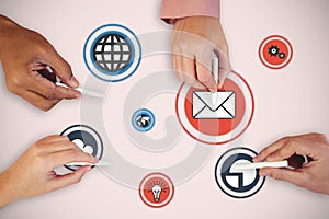 Composite image of cropped hands of people holding chalks