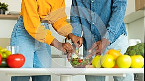 Cropped image of african american spouses cooking healthy vegetarian food in kitchen, panorama, closeup