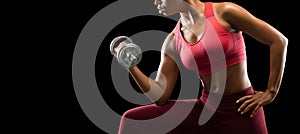 Cropped image of afro girl pumping barbell with one hand