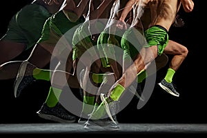 Cropped image of athletic, muscular, shirtless man in motion, running against black background with stroboscope effect.