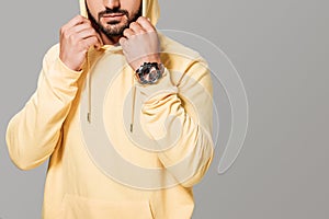 cropped image of bearded stylish man in yellow hoodie