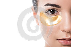 cropped image of beautiful girl with moisturizing under eye patch looking at camera