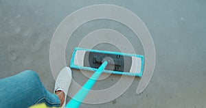 Cropped image of beautiful young woman in protective gloves using a flat wet-mop while cleaning floor in the house.