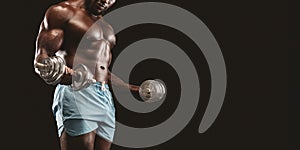 Cropped image of black bodybuilder pumping the iron