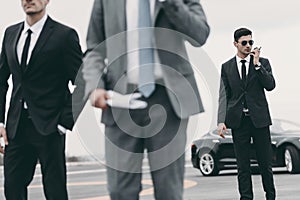 cropped image of bodyguards and businessman