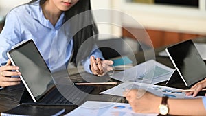 Cropped image of business development team discussing/talking/meeting at the modern meeting table .