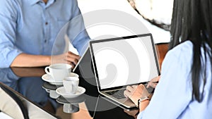 Cropped image of business development team working/using a computer tablet and laptop with white blank screen.